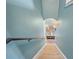 Light and airy stairwell with blue walls leading to an upper level at 35819 Diamond Head Ct, Zephyrhills, FL 33541