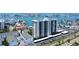 Stunning aerial view of a waterfront condo building with boat docks, parking, and beautiful water views at 400 Island Way # 1709, Clearwater Beach, FL 33767