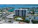 Aerial view showcasing the condo building, parking area, and inviting community pool at 400 Island Way # 1709, Clearwater Beach, FL 33767