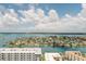 Picturesque aerial view of waterfront homes with boats and lush landscaping under a blue, cloudy sky at 400 Island Way # 1709, Clearwater Beach, FL 33767