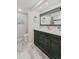 Elegant bathroom featuring a double vanity with a dark green cabinet and stylish coastal decorations at 400 Island Way # 1709, Clearwater Beach, FL 33767