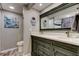 Elegant bathroom with a double sink vanity, framed mirror, and tasteful nautical decor at 400 Island Way # 1709, Clearwater Beach, FL 33767