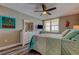Inviting bedroom featuring wood-look floors, cheerful decor, and a serene coastal view from the shuttered window at 400 Island Way # 1709, Clearwater Beach, FL 33767