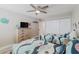 Cozy bedroom with light wood flooring, a ceiling fan, and comfortable twin beds with ocean-themed bedding at 400 Island Way # 1709, Clearwater Beach, FL 33767