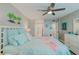 Coastal-themed bedroom with a queen-size bed, tropical decor, and access to an ensuite bathroom at 400 Island Way # 1709, Clearwater Beach, FL 33767