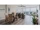 Bright dining area with wicker chairs and a glass table, offering ocean views from the adjacent balcony at 400 Island Way # 1709, Clearwater Beach, FL 33767