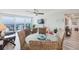 Bright dining area with wicker chairs and a glass table, offering ocean views from the adjacent balcony at 400 Island Way # 1709, Clearwater Beach, FL 33767
