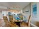 Dining room next to the kitchen with a glass table, wicker chairs and wood-look flooring at 400 Island Way # 1709, Clearwater Beach, FL 33767