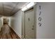 Hallway featuring wood-look floors and the door to unit 1709 at 400 Island Way # 1709, Clearwater Beach, FL 33767