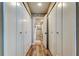 Hallway with multiple closets and an open view of the bathroom, highlighting storage and flow at 400 Island Way # 1709, Clearwater Beach, FL 33767