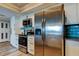 Kitchen features stainless steel appliances, light cabinetry, tile backsplash, and granite countertops at 400 Island Way # 1709, Clearwater Beach, FL 33767