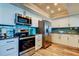 Bright kitchen with stainless steel appliances, white cabinets, and a backsplash at 400 Island Way # 1709, Clearwater Beach, FL 33767
