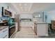 Modern kitchen features stainless steel appliances, granite countertops, and a breakfast bar at 400 Island Way # 1709, Clearwater Beach, FL 33767