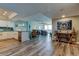 Open-concept living room with kitchen island and views of the balcony, with wood-look flooring at 400 Island Way # 1709, Clearwater Beach, FL 33767