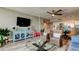 Spacious living room featuring wood-look flooring, modern furniture, and direct access to the kitchen at 400 Island Way # 1709, Clearwater Beach, FL 33767