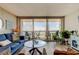 Cozy living room with comfortable seating and panoramic waterfront views through sliding glass doors at 400 Island Way # 1709, Clearwater Beach, FL 33767