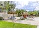 Resort style pool area with tiki umbrellas, tropical plants, lounge chairs, and a paver patio at 400 Island Way # 1709, Clearwater Beach, FL 33767
