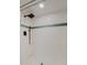 Close-up of a modern shower with textured tile surround and sleek, black fixtures at 400 Island Way # 1709, Clearwater Beach, FL 33767