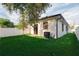 Spacious backyard with lush lawn, privacy fence, and shade tree at 4108 N Thatcher, Tampa, FL 33614