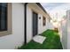 Exterior with backyard access, new stucco, and covered patio at 4108 N Thatcher, Tampa, FL 33614