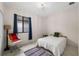 Bright bedroom with white walls, tile floor, window, and stylish chair at 4108 N Thatcher, Tampa, FL 33614