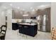 Modern kitchen featuring sleek cabinets, stainless steel appliances, island with seating, and modern lighting at 4108 N Thatcher, Tampa, FL 33614