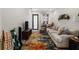 Open-concept living room with neutral sofa, TV, decorative rug, and ample natural light at 4108 N Thatcher, Tampa, FL 33614