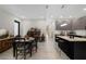 Open-concept living space with a dining area and modern kitchen featuring stainless steel appliances and an island at 4108 N Thatcher, Tampa, FL 33614