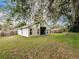 Spacious backyard featuring a partial view of the home and a wood fence at 412 Henderson Ave, Seffner, FL 33584