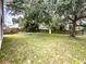 Large backyard with a privacy fence, grass and mature shade trees at 412 Henderson Ave, Seffner, FL 33584