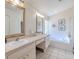 Bathroom features a double sink vanity, a soaking tub, and a glass shower at 412 Henderson Ave, Seffner, FL 33584