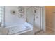 Bathroom with a soaking tub and glass enclosed shower at 412 Henderson Ave, Seffner, FL 33584