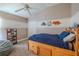 Cozy bedroom with twin bed, overhead fan, and charming wall decor at 412 Henderson Ave, Seffner, FL 33584