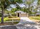 Inviting single-story home featuring a manicured lawn, mature trees, and convenient driveway at 412 Henderson Ave, Seffner, FL 33584