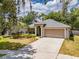 Pretty home featuring manicured landscaping, a garage, and mature shade trees at 412 Henderson Ave, Seffner, FL 33584