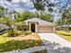 Charming single-story home with well-maintained lawn, mature trees, and inviting curb appeal at 412 Henderson Ave, Seffner, FL 33584