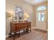 Inviting foyer features a decorative console table, lamps, and a patterned rug at 412 Henderson Ave, Seffner, FL 33584