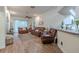 Bright living room features hardwood floors, ceiling fan, and natural light at 412 Henderson Ave, Seffner, FL 33584