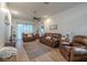 Spacious living room boasts comfortable leather furniture, neutral paint, and lots of natural light at 412 Henderson Ave, Seffner, FL 33584