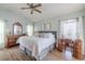 Bedroom with large window, ceiling fan, dresser, and hardwood floors at 412 Henderson Ave, Seffner, FL 33584