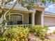Cozy front porch with seating, complemented by charming landscaping at 412 Henderson Ave, Seffner, FL 33584