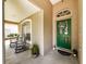 Front entryway features a beautiful green front door and cozy rocking chairs at 412 Henderson Ave, Seffner, FL 33584