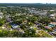 Aerial perspective of the property set amongst lush surroundings with a view of the city skyline at 4513 S Hesperides St, Tampa, FL 33611