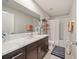Bright bathroom featuring a modern vanity, a well-lit mirror, and a shower-tub combination at 4533 Eternal Prince Dr, Sun City Center, FL 33573