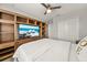 Comfortable bedroom featuring a large TV, wooden entertainment center, and soft bedding at 4533 Eternal Prince Dr, Sun City Center, FL 33573
