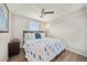 Cozy bedroom features a comfortable bed with blue accents, wood flooring, and a ceiling fan at 4533 Eternal Prince Dr, Sun City Center, FL 33573