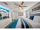 A well-lit bedroom features a plush rug, king bed, ceiling fan, and stylish decor at 4533 Eternal Prince Dr, Sun City Center, FL 33573