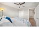 Bright bedroom features a ceiling fan, white closet, and a comfortable bed with a view to the doorway at 4533 Eternal Prince Dr, Sun City Center, FL 33573