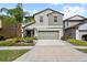 Two story home with a two car garage, beautiful landscaping and a palm tree in the front yard at 4533 Eternal Prince Dr, Sun City Center, FL 33573