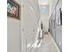 Hallway featuring custom wainscoting, artwork, and plenty of natural light at 4533 Eternal Prince Dr, Sun City Center, FL 33573